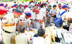Police personnel go through their duty schedule for deployment at polling booths in Rajpura on Tuesday.