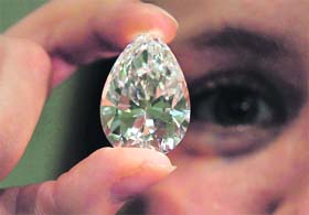 Flawless diamond: A Christie's employee holds a pear shaped D colour flawless 75.97 carat diamond at an auction house in London on Tuesday