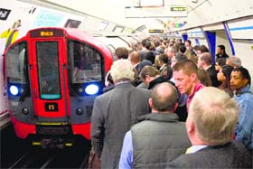 London tube strike: Commuters board an underground train at Kings Cross station in London on Tuesday