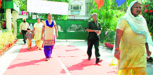 Voters walk down the red carpet at a polling both in Amritsar on Wednesday.