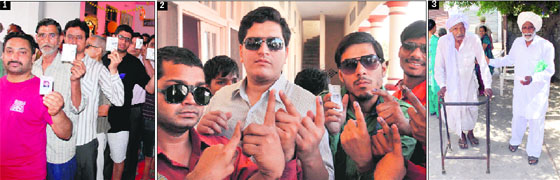 1. People wait in a queue to cast their votes; 2. Visually impaired voters show inked fingers after casting their votes; 3. A man helps an elderly person in Amritsar on Wednesday.