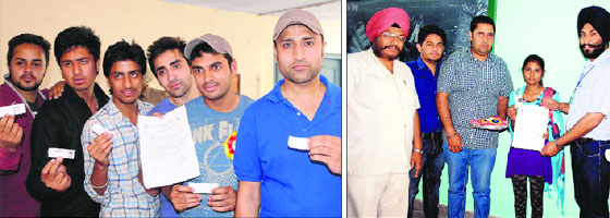 First time voters show voting cards and certificates awarded to them by electoral officers at polling booths in Amritsar on Wednesday.
