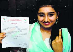 Harkirat Badal, daughter of Deputy CM Sukhbir ,Badal shows her appreciation certificate after casting her vote for the first time at Badal village in Bathinda on Wednesday