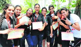 Players of the Dynamite Club flash the victory sign after winning the Kailash Bahl Netball Trophy at Sector 7, Chandigarh, on Wednesday.