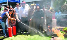 Fire Department officials give tips to employees of the bank during a mock drill in Sector 17, Chandigarh, on Wednesday.