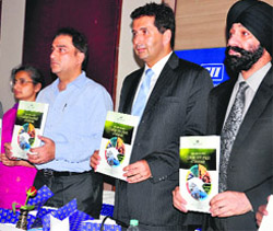 Chairman of CII, Northern Region, Zubin Irani (second from right), and other members launch the annual book of the CII during a press conference in Dehradun on Wednesday.