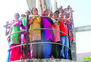 Residents of Prem Nagar protest atop an overhead water tank in Dehradun on Wednesday. 
