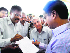 Protesters submit a memorandum against excessive toll to the Deputy Commissioner in Rewari on Wednesday. 