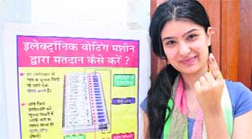 First-time voter Shilpa shows her marked finger after casting her vote at Muthi migrant camp in Jammu on Wednesday.