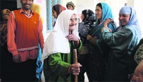 An elderly woman smiles after casting her vote at Budgam in Srinagar on Wednesday
