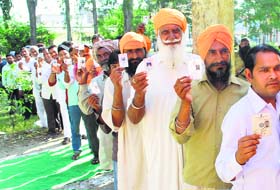 Poll zeal: People vote in a queue to cast their vote in Majitha (Amritsar) on Wednesday