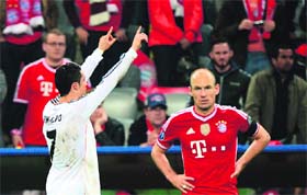 Real Madrid's Cristiano Ronaldo celebrates scoring his teams fourth goal as Bayern Munich's Arjen Robben looks on in disappointment during the Champions League second-leg semifinal in Munich on Tuesday