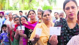 Women stand in a queue to vote in Bathinda.