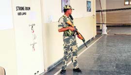 A security personnel guards the strong room where the EVMs have been sealed and stored in Bathinda on Thursday.