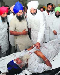 Manpreet Badal asks about the well being of his supporter, who was injured during polling, at the Civil Hospital in Bathinda on Thursday.