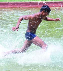 A boy tries to beat the heat at Boat Club in New Delhi on Thursday.