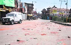 A deserted road where a stone-throwing incident took place following the killing of a youth in Srinagar, on Thursday. tribune Photo: Yawar Kabli