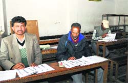 Polling officials wait for voters inside a polling station in the old city of Srinagar on Thursday. Tribune photo: Amin War
