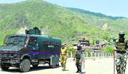Securitymen at a barricade in Baramulla on Thursday. A tribune photo