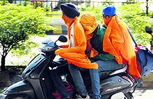 Three boys do triple riding to fight the summer heat in Jalandhar