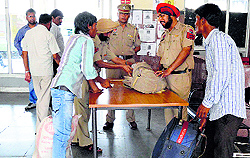 Following twin bomb blasts at the Chennai railway station, police officials check baggage at the Ludhiana railway station on Thursday