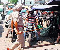 SHO Gurmit Singh at the protest site near Aarti Steel in Ludhiana on Thursday; and (below) a protester shows injury marks