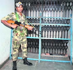 A CRPF jawan guards a room with EVMs in Patiala on Thursday.