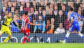Atletico Madrid's Turkish midfielder Arda Turan scores his team's third goal against Chelsea during the UEFA Champions League semifinal second leg match in London on Wednesday.