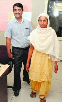 Harjinder Kaur with doctor Dinesh Gupta after sugery of her spinal cord in Bathinda on Friday.