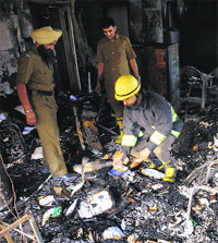 Firefighters at the gutted office of the Directorate of Institutional Finance and Banking, Punjab, in Chandigarh on Friday. 