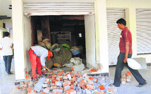 UT Estate Office staff remove an illegal construction at Hotel Jalandhar in Sector 18, Chandigarh, on Friday.