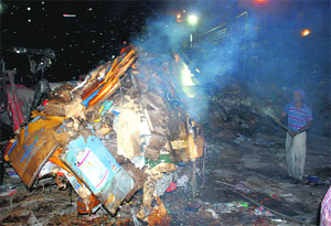 A man douses the flames at Nachiketa Papers Limited on the Mubarakpur-Ramgarh Road in Dera Bassi on Thursday night. 