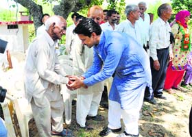 BJP MP Anurag Thakur interacts with people during his election campaign in Bilaspur