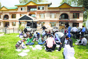 Employees review voter list at the District Election Office in Baramulla.