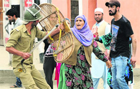 a woman scuffles with a policeman.