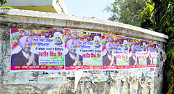 Posters of Lok Sabha candidates dot walls of public and private buildings