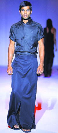A model walks the ramp in an outfit designed by Arjun Saluja