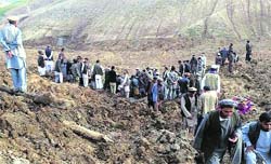 Afghan villagers gather at the site of a landslide in Argo district of Afghanistan on Friday. Reuters 