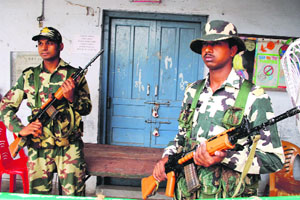 Securitymen guard EVMs kept in a strong room at a government school at Mall Road in Amritsar on Saturday.