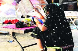 A woman fans a child on a hot day in Bathinda on Saturday. Tribune photo: Pawan Sharma