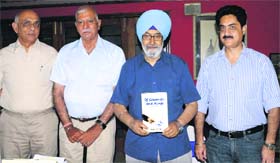 Justice (retd) SS Sodhi (second from right) releases a book of Harish Dhillon (third from right) at the CGA Golf Range in Chandigarh on Saturday. Also seen in the picture are Rajan Kashyap (extreme left) and Capt Mohanbir (extreme right)