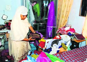 A woman looks at the ransacked room of her house at Zamidara Enclave in Zirakpur on Saturday