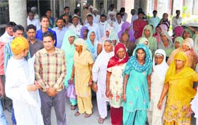 Residents of Kalram village outside the SPs office at the Mini-Secretariat in a land consolidation case in Karnal.