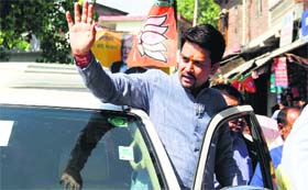 BJP candidate Anurag Thakur during a roadshow at Dehra on Saturday.