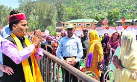 BJP candidate Ram Swaroop Sharma greets his supporters in Mandi.