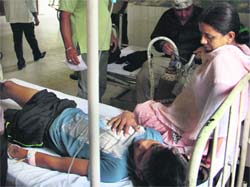 Gagandeep, who was allegedly subjected to third-degree torture by the police, receives treatment at the Civil Hospital in Jalandhar on Saturday. Photo: Sarabjit Singh