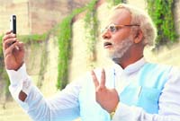 Comedian Manish Jangra mimics BJPs prime ministerial candidate Narendra Modi while promoting a comedy show in Ludhiana on Saturday. Photo: Inderjeet Verma