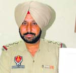 Inspector Gurdev Singh, SHO, Model Town police station, shows a pamphlet being distributed among senior citizens. Photo: Inderjeet Verma 