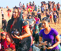 Devotees carry water-filled earthen pots to pour on Grahraj Sanidev in Cuttak
