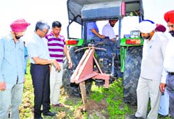 Officials inspect sub-soil chiseler in Ropar on Saturday. Tribune photo